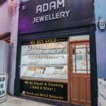 The storefront of a jewellery store with a sign that reads 'Adam Jewellery'