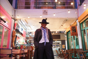 The Black Farmer standing in the centre of Market Row Brixton Village