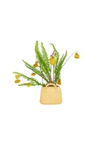 Flower vase in the shape of a yellow handbag.