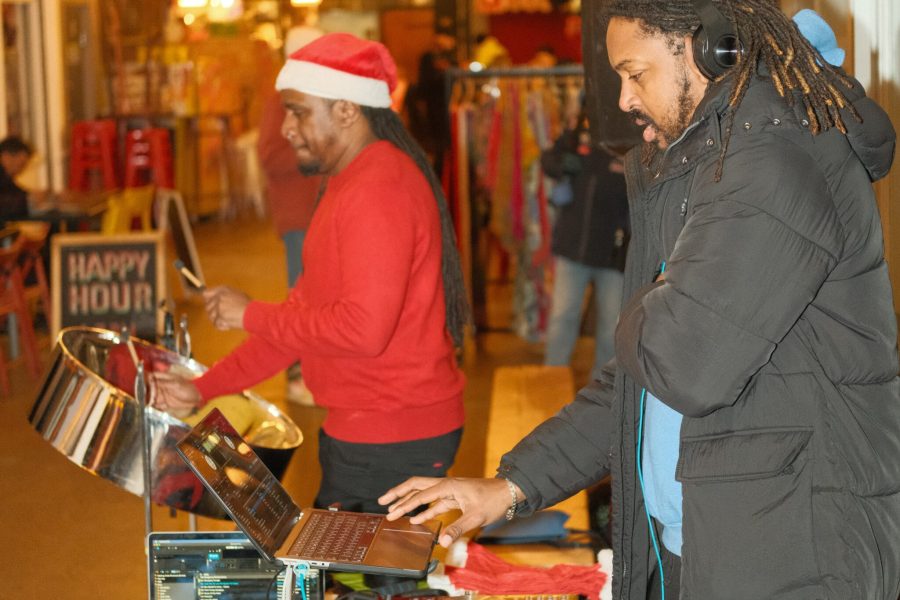 Two men playing the drums in festive attire.