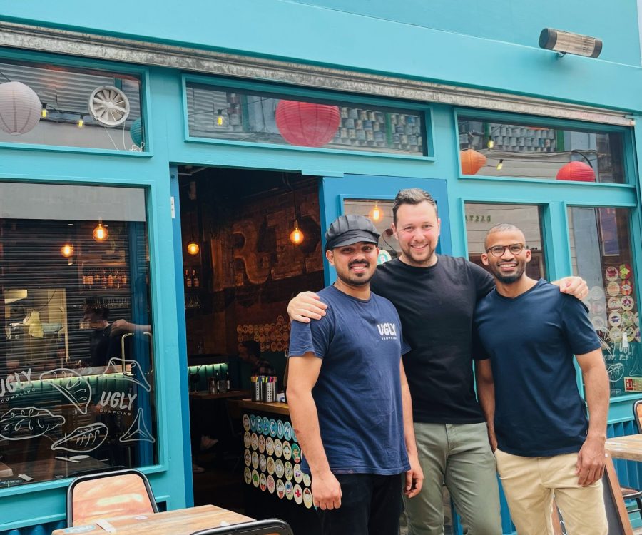 Team of three men standing outside the Ugly Dumpling restaurant